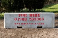 Concrete security barrier for hire with BlockAid UK branding