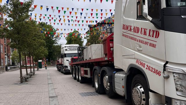 Concrete ballast delivery trucks for event setup and barrier hire services