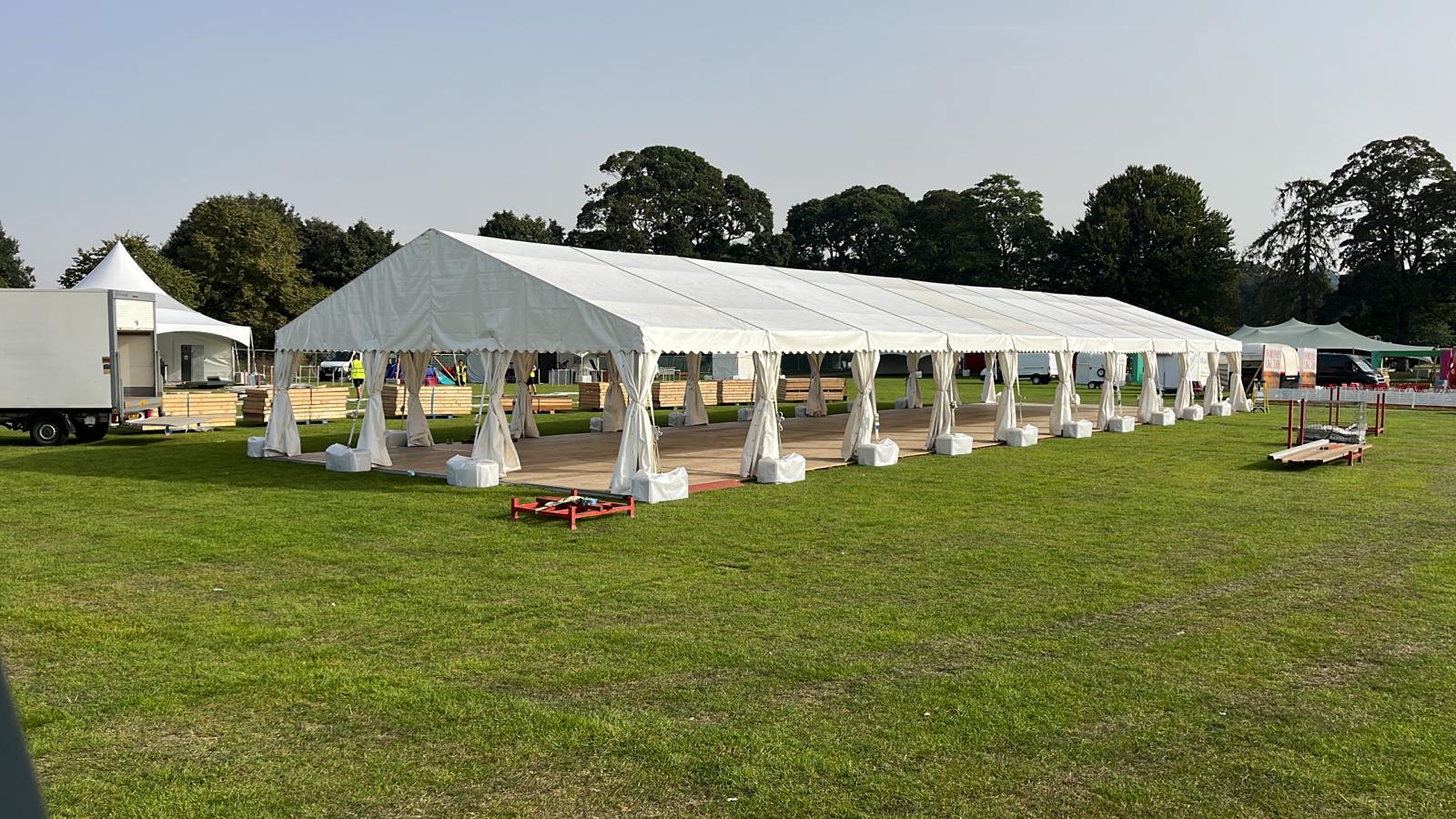 Large outdoor marquee tent setup on grass for events and weddings