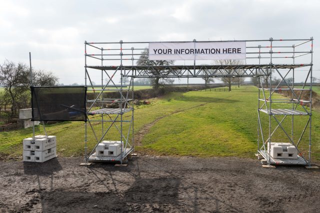 Temporary scaffold structure secured with concrete block weights