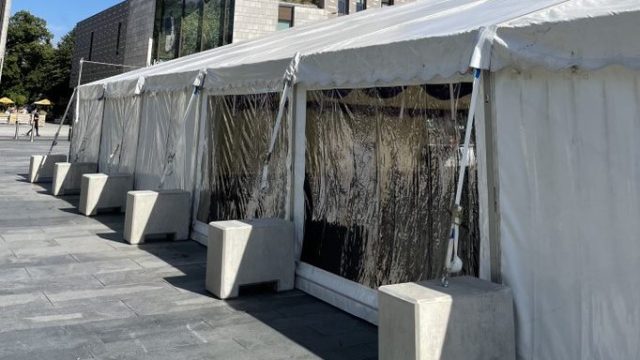 White marquee tent with concrete weights