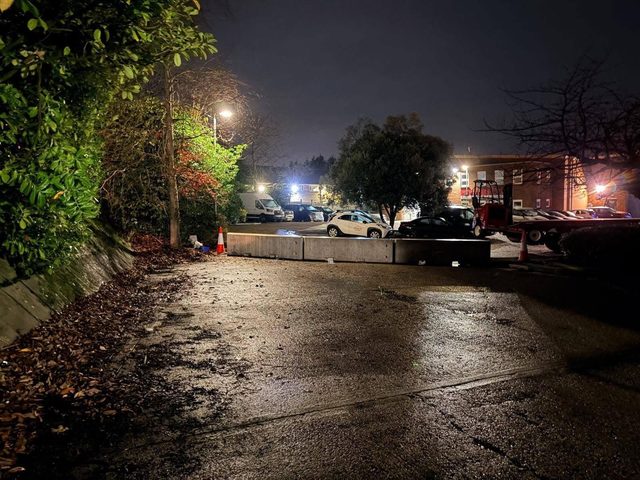 Heavy concrete weight blocks securing access to a car park at night